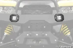 Two recessed LED cube lights flush mounted in the front bumper of a UTV and lit up
