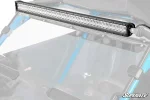 LED light bar mounted along the front roof edge of a UTV