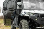 Can-Am Defender HD9 cab enclosure doors shown installed on the machine, additional in-use photo