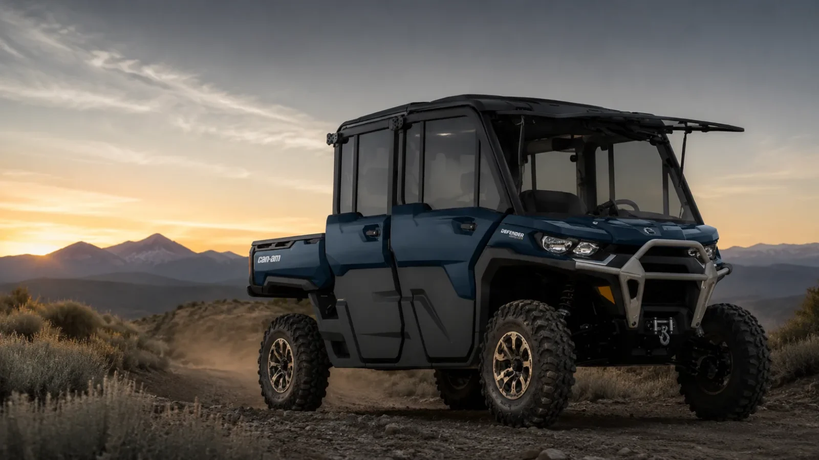Can-Am Defender MAX cab model on a mountain trail at sunset