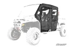 Four black soft cab enclosure doors with clear zip windows fitted to a camo Can-Am Defender MAX, front three-quarter view