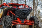 Tube rear bumper installed on a red and gold Can-Am Maverick X3 parked in bare winter woods