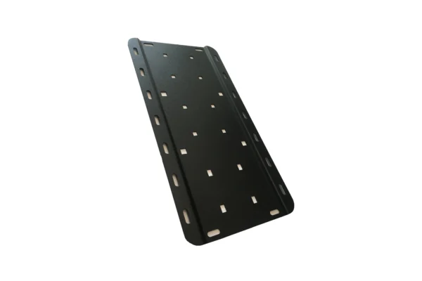 Long black slotted FuelpaX universal mounting plate with square and oval holes, angled view