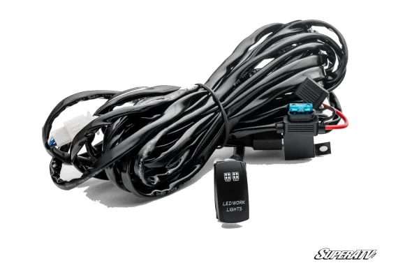 Coiled black LED light wiring harness with inline blade fuse holder and a rocker switch marked LED WORK LIGHTS