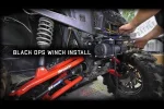 Install video still showing a winch mounted behind a UTV front end with the mounting plate fitted