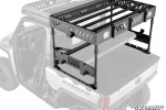 Black slotted bed rack raised on four legs over the bed of a white Polaris Ranger XD 1500