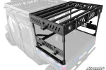 Black raised bed rack with slotted crossbars standing on four legs over the bed of a blue Polaris Ranger