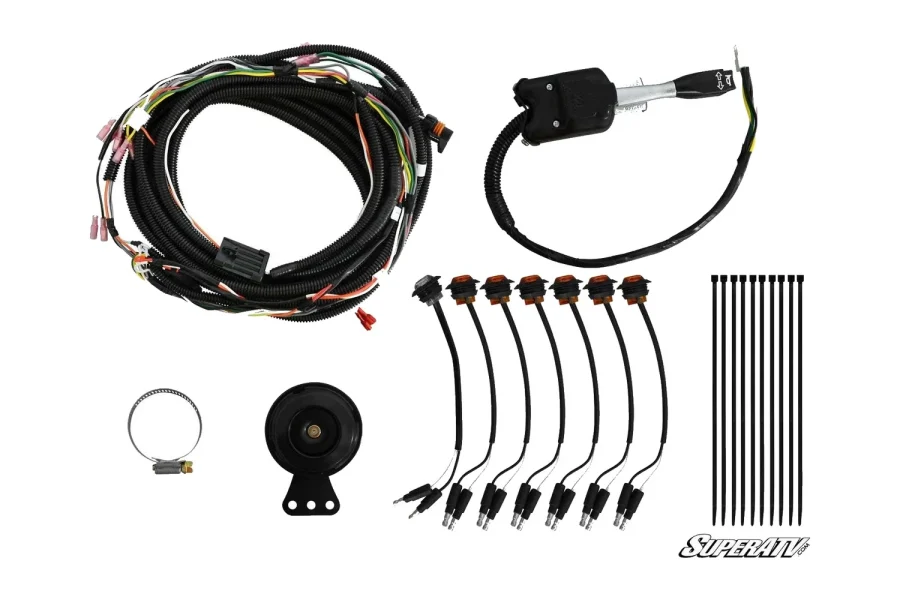 Turn signal kit contents laid out with a wiring harness, switch, horn, amber indicator lights and zip ties