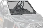 Full windshield fitted between the hood and roof of a Polaris RZR Pro R with black trim around the edge