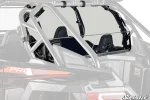 Tinted rear windshield clamped behind the seats of a Polaris RZR, held to the rear cage tubes with straps and brackets
