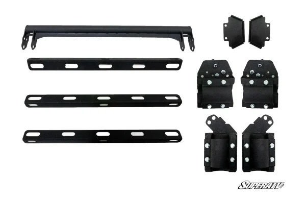 Cargo rack hardware laid out: tubular crossbar, three slotted mounting rails and clamp brackets