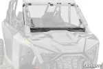 Clear hinged flip windshield mounted across the front cage of a Polaris RZR Pro XP with a rubber seal along the hood