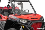 Clear full windshield clamped to the front cage tubes of a red Polaris RZR