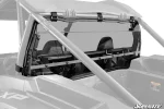 Clear rear windshield strapped between the cage tubes behind the seats of a Polaris RZR