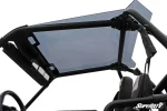 Smoke-tinted roof over a Polaris RZR cab, viewed from the seats looking up through the panel at the black roll cage