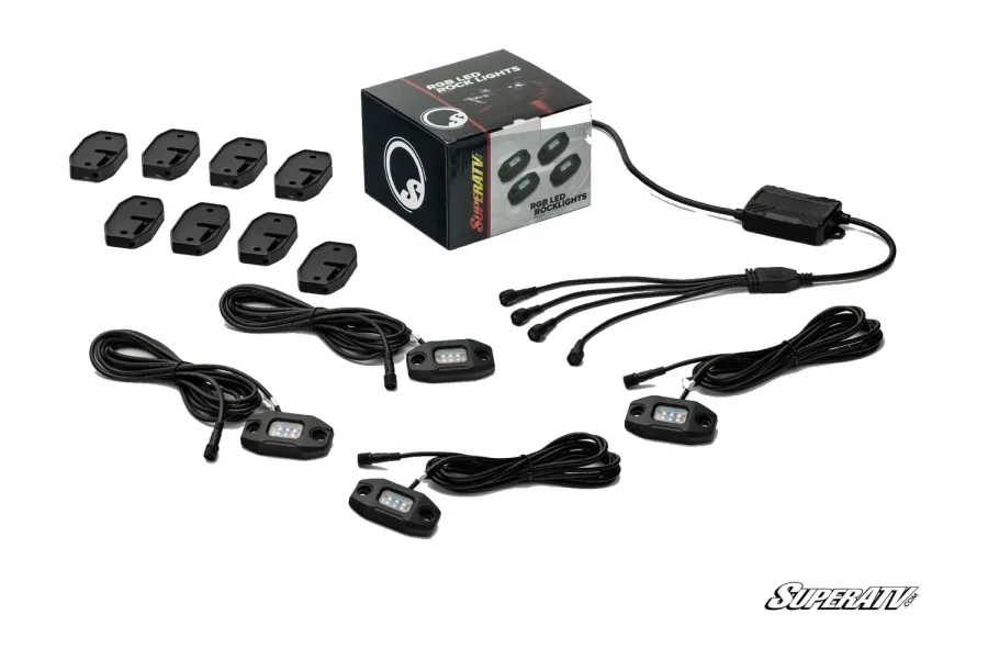 RGB rock light kit laid out with sealed LED pods, mounting plates, wiring harnesses and a control module