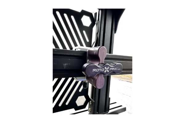 RotoPax T knob and adapter plate clamped to a black aluminum extrusion rack rail, outdoor close-up