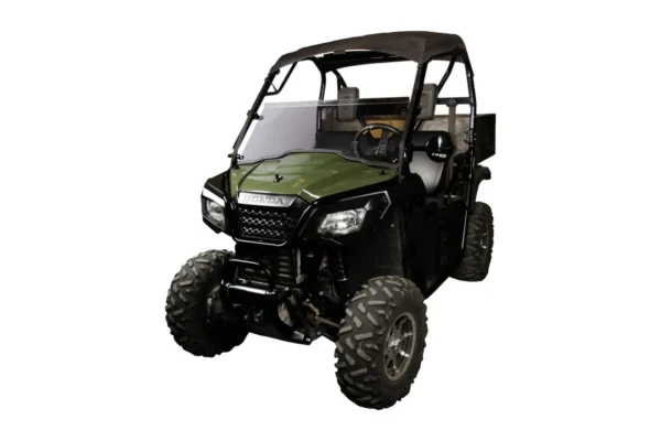 Tusk hinged UTV windshield mounted on a green Honda Pioneer, front three-quarter view