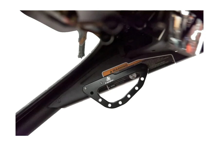 Tusk black billet grab handle bolted to the A-pillar cage tube of a Can-Am Maverick X3, detail view