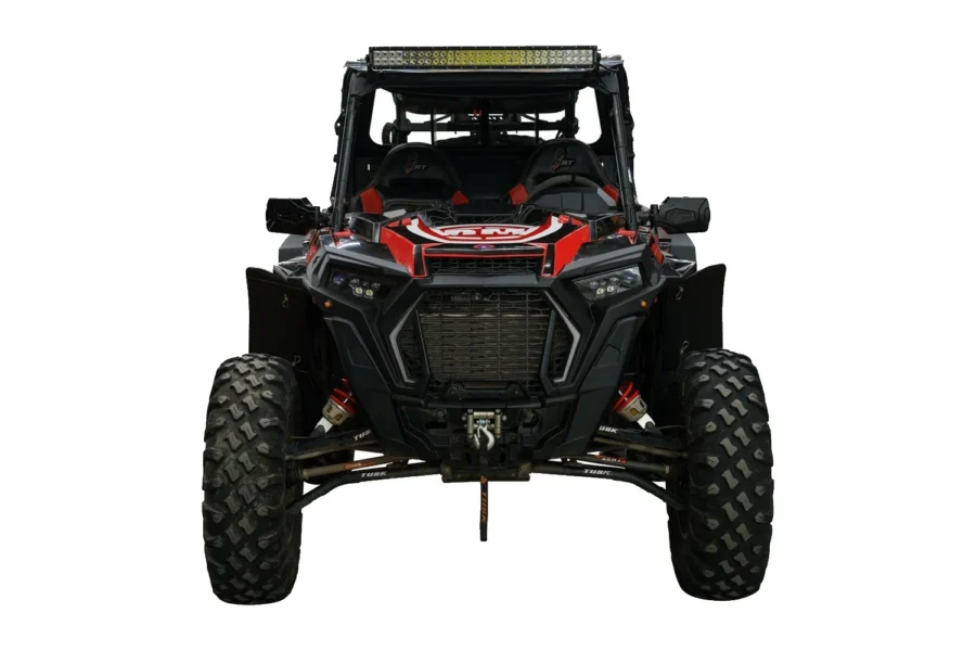 Head-on front view of a black and red Polaris RZR with a roof light bar and Tusk suspension