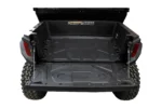 Tusk bed mat installed in the cargo bed of a Polaris General with the tailgate down, rear view