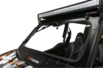 Close-up of the windshield wiper and Tusk-branded frame mounted on the Kawasaki KRX