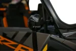 Tusk alloy mirror mounted on an orange and black Polaris RZR, back of the mirror shown