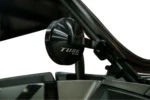Close-up of a Tusk alloy mirror clamped to a UTV roll cage, back of the housing