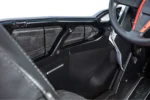 Interior view of a black Tusk lower door insert panel inside a RZR cockpit