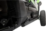 Black Tusk rock slider installed along the rocker of a green Kawasaki Teryx KRX