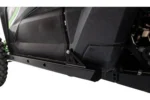 Close view of a black Tusk rock slider bracket mounted under the door of a green Teryx KRX