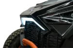 Close-up of the illuminated white accent light strip beside the headlight on a RZR Pro