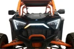 Front view of the RZR Pro with the accent light showing an amber turn signal on the left