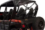Tusk clear rear window installed behind the seats of a red and black Kawasaki Teryx4