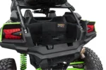 Tusk bed rack loaded with a gray dry bag and white cooler in a Kawasaki UTV bed