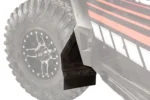 Tusk front mud flap mounted at the rear of the front fender of a Polaris RZR, close view of the flap and tire