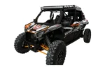 Tusk full view glass windshield installed on a black and orange Kawasaki Teryx KRX, front three-quarter view