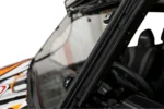 Close-up of the Tusk glass windshield edge and A-pillar clamp on a Kawasaki KRX