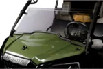 Close-up of the Tusk windshield hinge and lower panel on the green Honda Pioneer hood
