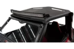 Curved Tusk LED light bar mounted across the front of a black UTV roof over the windshield